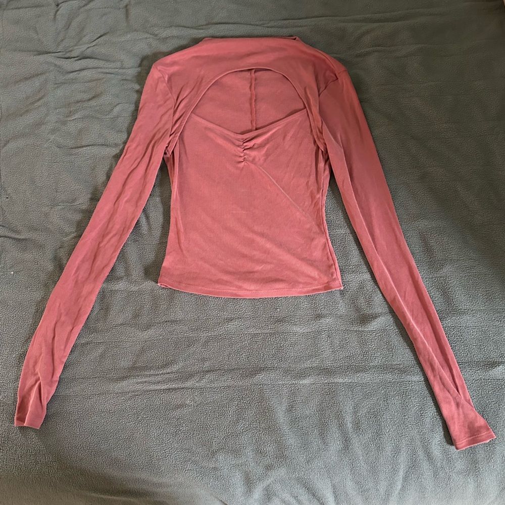 Pink long sleeve top with chest cut out, size extra small.